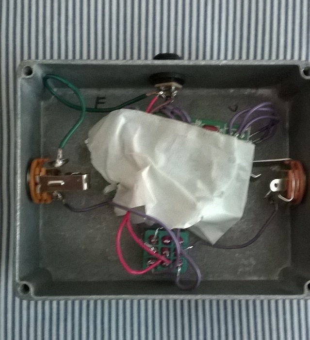 I find the masking tape shield adds a little presence to the treble frequencies that electrical tape just doesn't have