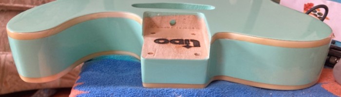 the color variation is particularly noticeable around the cutaway and next to the neck pocket.