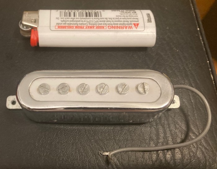 lighter for scale. about 1 mm larger than a Tele bridge pickup all around.